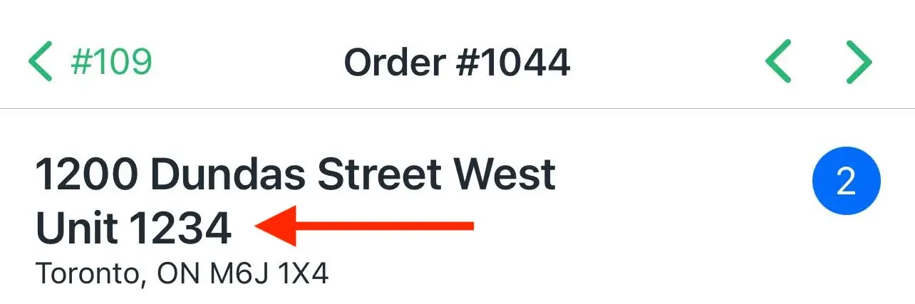 The EasyRoutes driver app stop screen for Order #1044, an arrow pointing to Unit 1234 shown on its own line below the street address