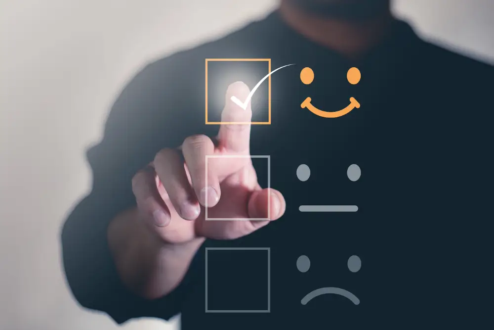 A finger ticking the happy face on a three-point satisfaction rating